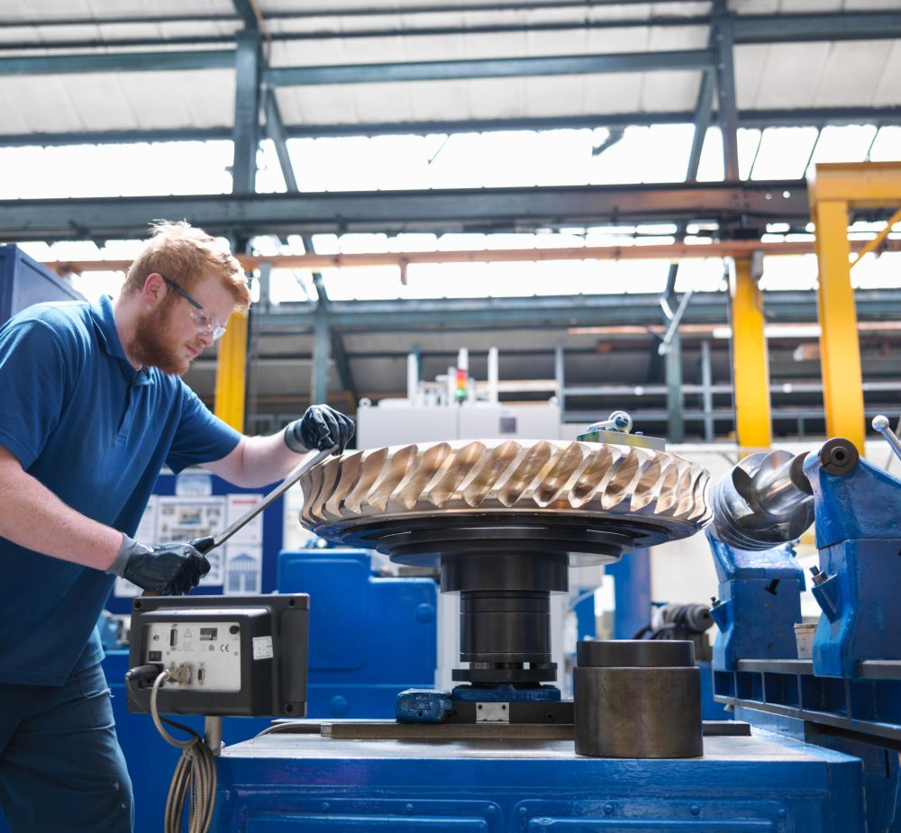 engineer finishing bronze gear wheel in engineering factory engineer finishing bronze gear wheel in engineering factory